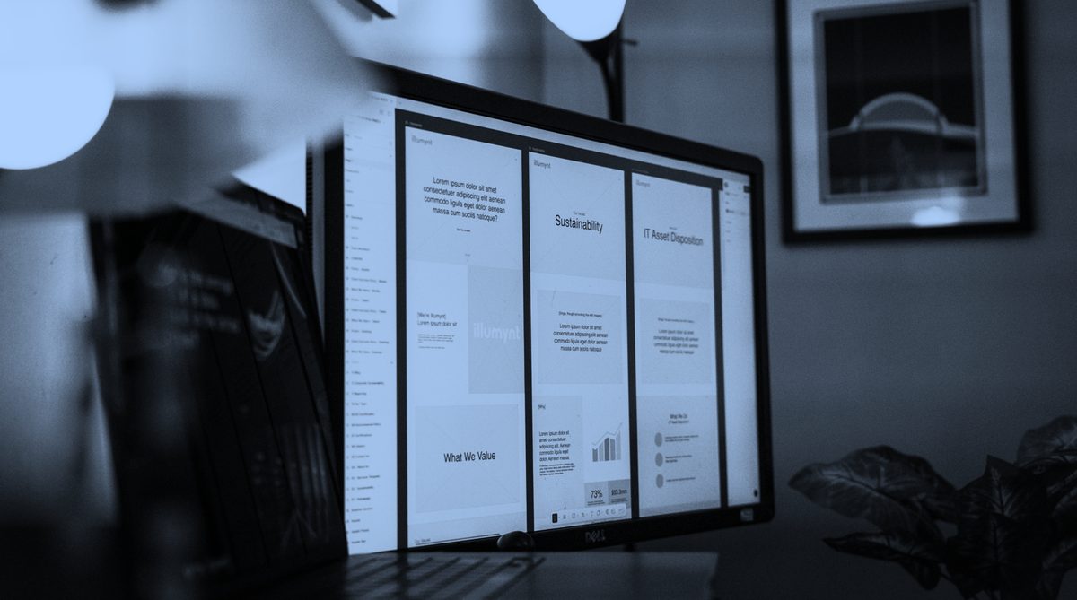 A darkly lit, monochromatic blue image of a desktop monitor displaying a presentation with "Sustainability" and "IT Asset Disposition" slides visible. A small plant sits to the right of the screen, while a framed picture hangs on the wall in the background, all bathed in a cool, contemplative glow. The overall mood is focused and modern.